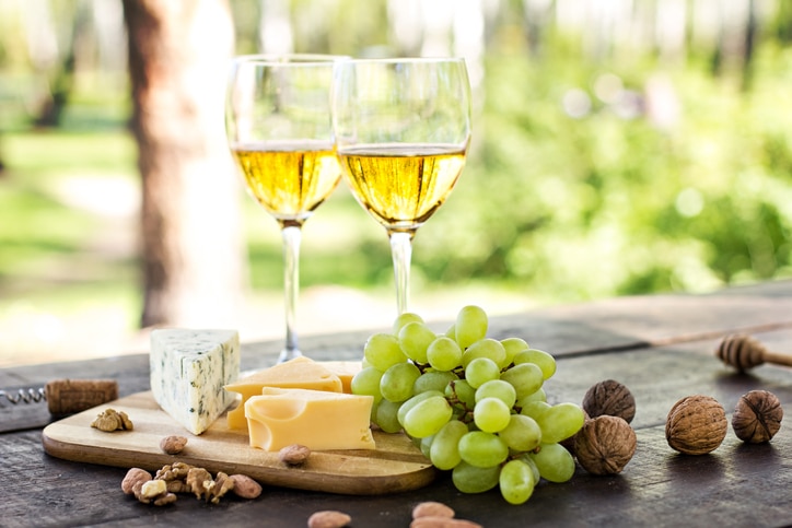 Wine, grapes, nuts, cheese, blue cheese. Dinner, lunch, romantic date, picnic, eating on nature.
